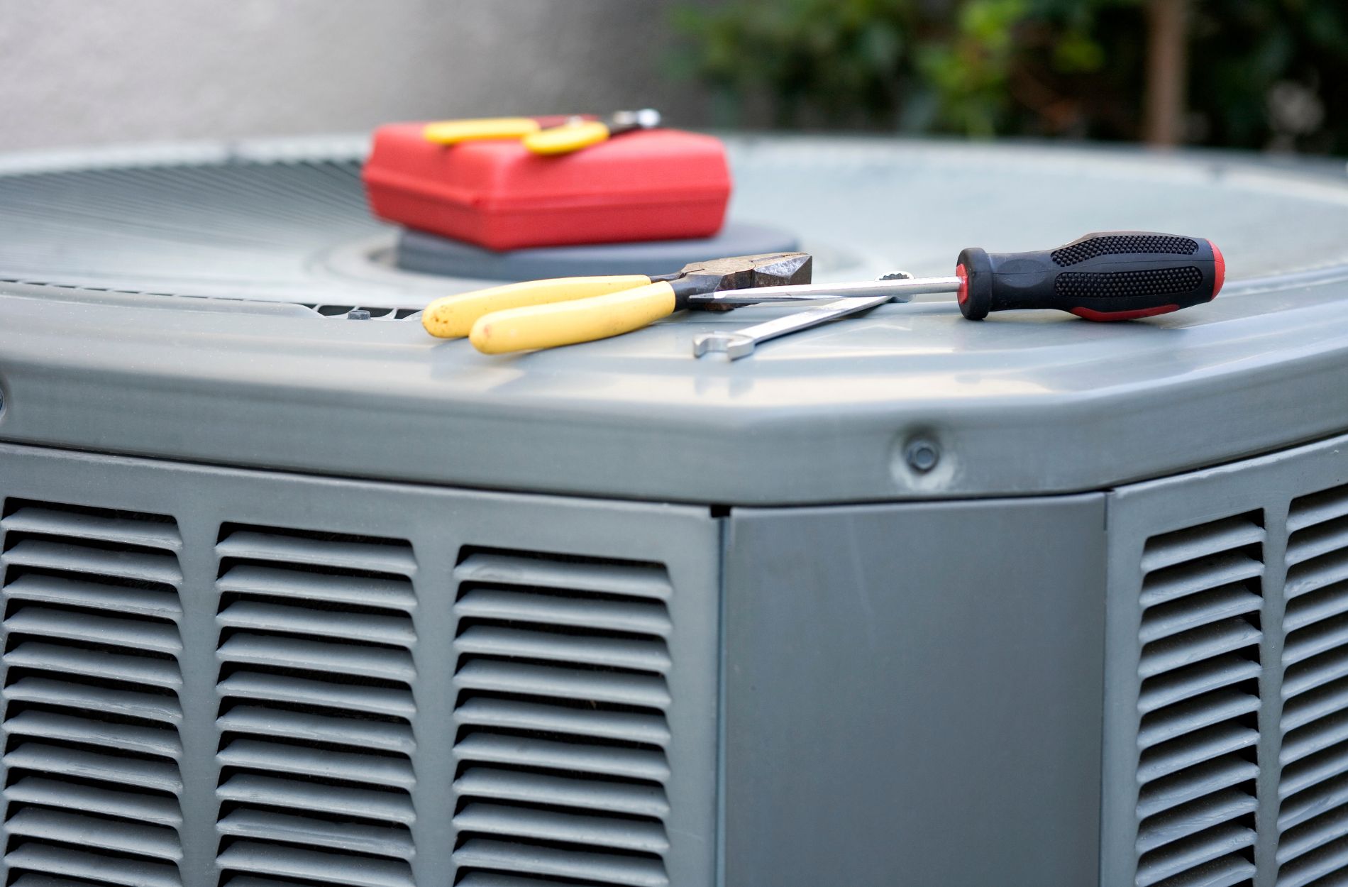 An HVAC technician is diligently servicing an HVAC unit, ensuring optimal performance and efficiency.