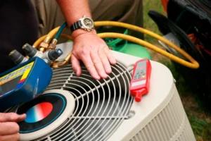 A man inspects an air conditioner using a tool, ensuring it operates efficiently and effectively.